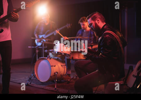 Rear view of band performing in recording studio Stock Photo