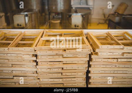 Stacks of honey wooden frames in factory Stock Photo