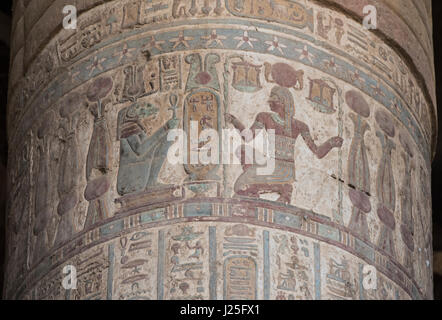 Hieroglypic colourful carving paintings on a large stone column at the ancient egyptian temple of Khnum in Esna with god Sobek Stock Photo
