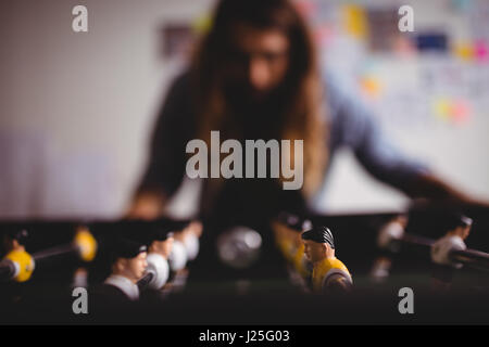 Blur man playing table football game Stock Photo