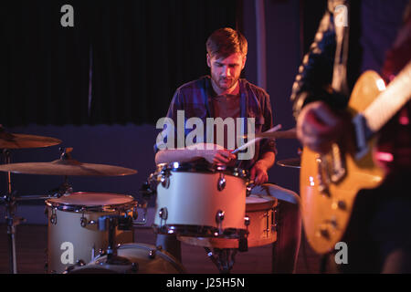 Drummer playing drums in recording studio Stock Photo