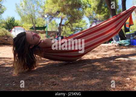 Girl resting on a hammock in Hvar island, Croatia Stock Photo