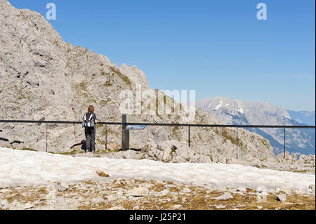 A woman admiring the Panoramic view of the mountain range from Hafelekar, Tirol, Austria Stock Photo