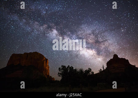 Milky Way galaxy and starry night sky over Bell Rock in Sedona, Arizona Stock Photo