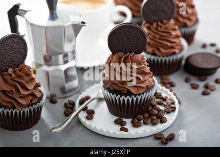 Chocolate coffee cupcakes with dark frosting decorated with sandwich cookies Stock Photo
