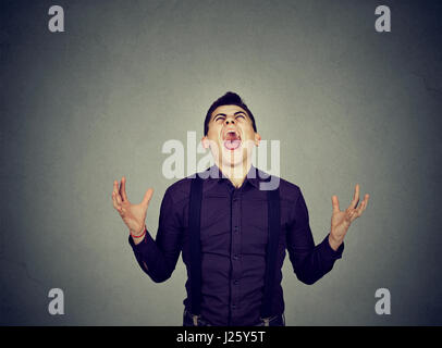 Frustrated desperate young man screaming Stock Photo