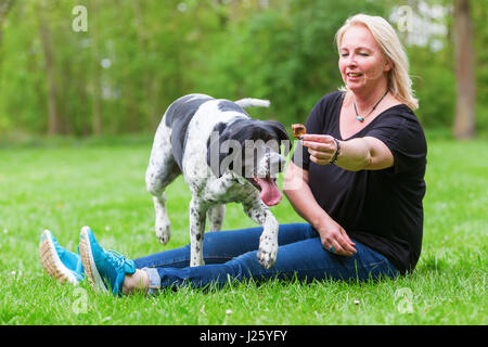 woman plays with her mixed breed dog outdoors Stock Photo