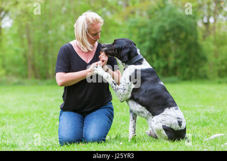 woman plays with her mixed breed dog outdoors Stock Photo