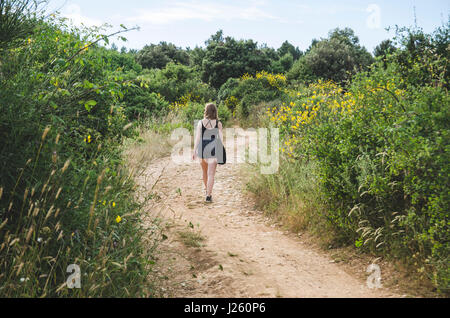 Young Woman Walking Along Path in Field, Kamenjak National Park, Premantura, Croatia Stock Photo