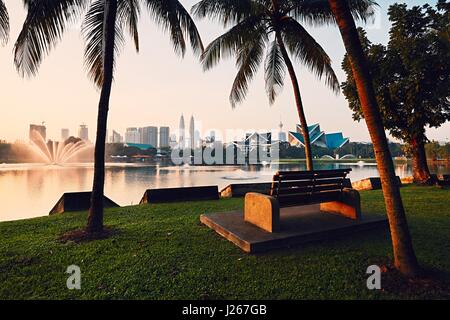 Beautiful morning in public park in Kuala Lumpur. Skyline of the modern city at sunrise. Stock Photo