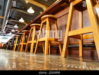 wooden bar stools in a row Stock Photo