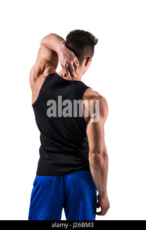 Attractive muscular young man's back , in t-shirt and short, massaging his own neck, isolated on white background Stock Photo