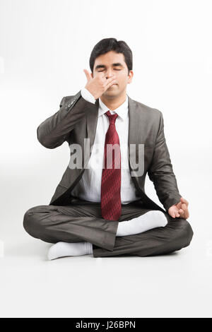 smart and young indian male businessman in business attire doing activities, isolated over white background Stock Photo