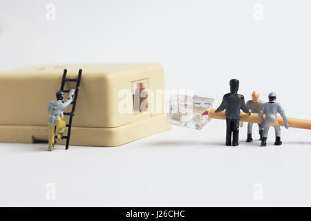 The miniature man plugging in phone cable connector, close up shot Stock Photo