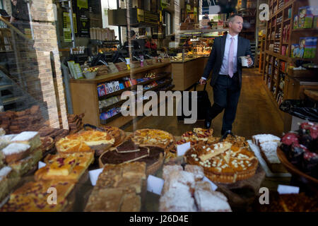 Businessman buying coffee at a patisserie in London, England, UK, Europe Stock Photo