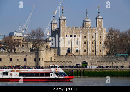 City Cruises tourist boat navigating the river Thames in front of the White Tower of the Tower of London Stock Photo