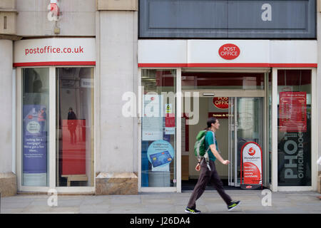 A man with a backpack walks by the post office in London, England, UK, Europe Stock Photo