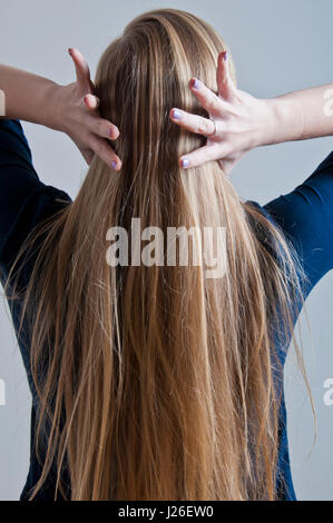 blond girl touching hair Stock Photo