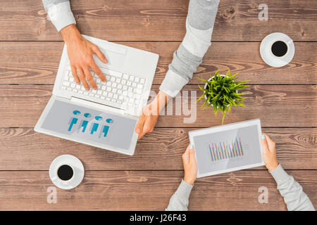 Man and woman working on computer and tablet in office Stock Photo