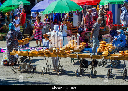 TASHKENT, UZBEKISTAN - AUGUST 24: Traditional uzbek bread called non or lepeshka for sale in the trolleys at Chorsu bazaar in Tashkent. August 2016 Stock Photo