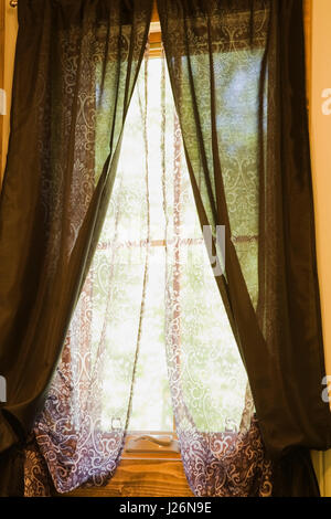 Curtains in the upstairs bathroom inside a residential log home Stock Photo
