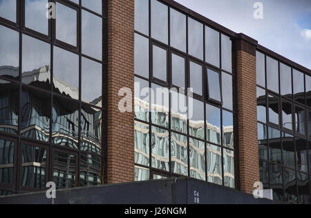 buildings reflected in glass front Stock Photo