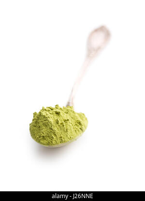 Green matcha tea powder in spoon isolated on white background. Stock Photo