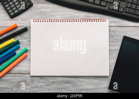 Top view of an opened notebook on a wooden desk. Stock Photo