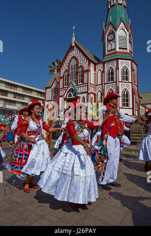 Members of a Pueblo dance group in ornate costumes performing at the annual Carnaval Andino con la Fuerza del Sol in Arica, Chile. Stock Photo