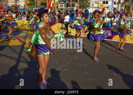 Members of a Pueblo dance group in ornate costume performing at the annual Carnaval Andino con la Fuerza del Sol in Arica, Chile. Stock Photo