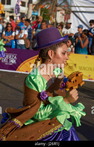 Members of a Pueblo dance group in ornate costume performing at the annual Carnaval Andino con la Fuerza del Sol in Arica, Chile. Stock Photo