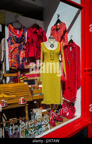 Secondhand dresses for sale in the window of a Shelter charity shop in Edinburgh. Stock Photo