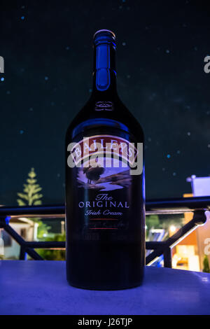 Irish liqueur in front of blurred night sky Stock Photo