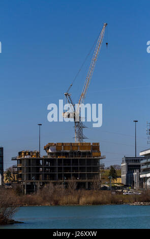 A new building being built on a shoreline Stock Photo