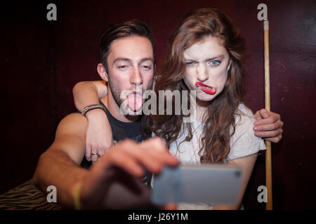 Young couple taking selfies on a cell phone Stock Photo