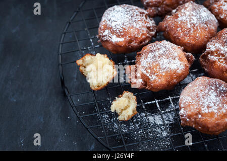 Fresh delicious homemade warm apple fritters on dark Stock Photo