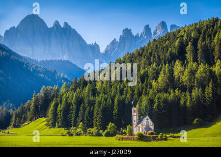 Idyllic mountain scenery in the Dolomites with baroque Church of St. Johann of Nepomuk and famous Odle Group in the background, South Tyrol, Italy