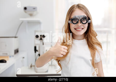Cool positive girl trying different lenses Stock Photo