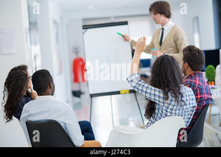 business, startup and people concept - happy creative team talking in office Stock Photo