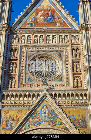 Close up of a gable with mosaics depicting the the Virgin Mary created between 1350 and 1390 after designs by artist Cesare Nebbia and the rose window Stock Photo