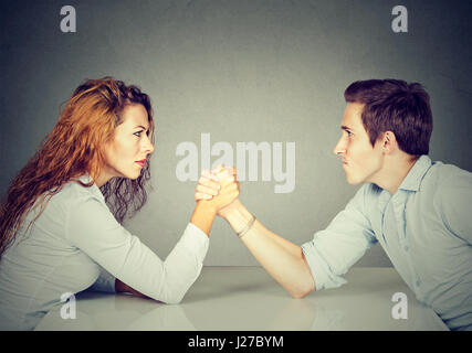 Business people woman and man arm wrestling Stock Photo