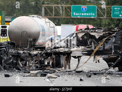 Los Angeles, USA. 25th Apr, 2017. A policeman works at the scene after a multi-vehicle crashed on a freeway near the Griffith Park in Los Angeles, the United States, April 25, 2017. A fiery crash involving two big rigs and multiple passenger vehicles left one person dead and nine others injured, and forced the closure of the Golden State (5) Freeway in both directions Credit: Zhao Hanrong/Xinhua/Alamy Live News Stock Photo