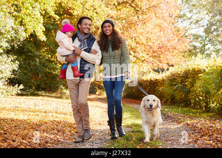 Family With Daughter And Dog Enjoy Autumn Countryside Walk Stock Photo ...