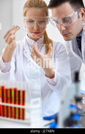Two young medical researcher doing microbiology experiment Stock Photo