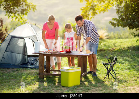 Family on vacation having barbecue in nature Stock Photo