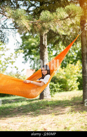 Young nice girl resting in hammock in nature Stock Photo