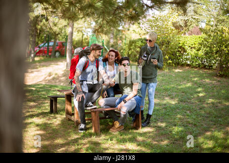 Group of hikers on break of walking in nature Stock Photo