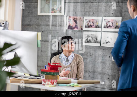 Two young designers discussion at work Stock Photo