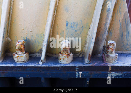 Big rusty metal nuts locked with rust and corrosion bolts Stock Photo