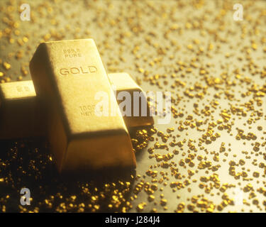 Gold bar 1000 grams, in the middle of gold nuggets. Gold exploration and mining concept. Stock Photo